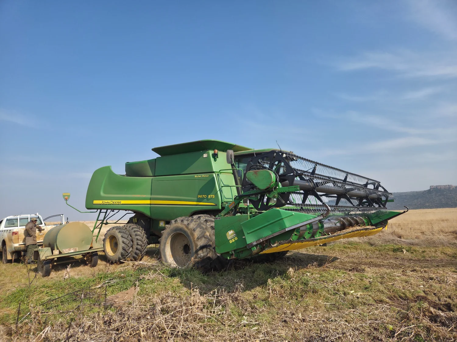 John Deere combine harvester in a field