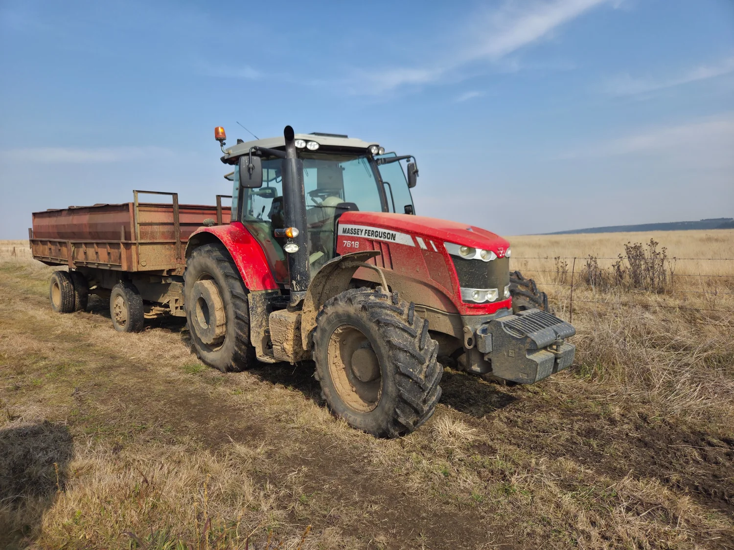 Red Massey Ferguson 7618 tractor with trailer