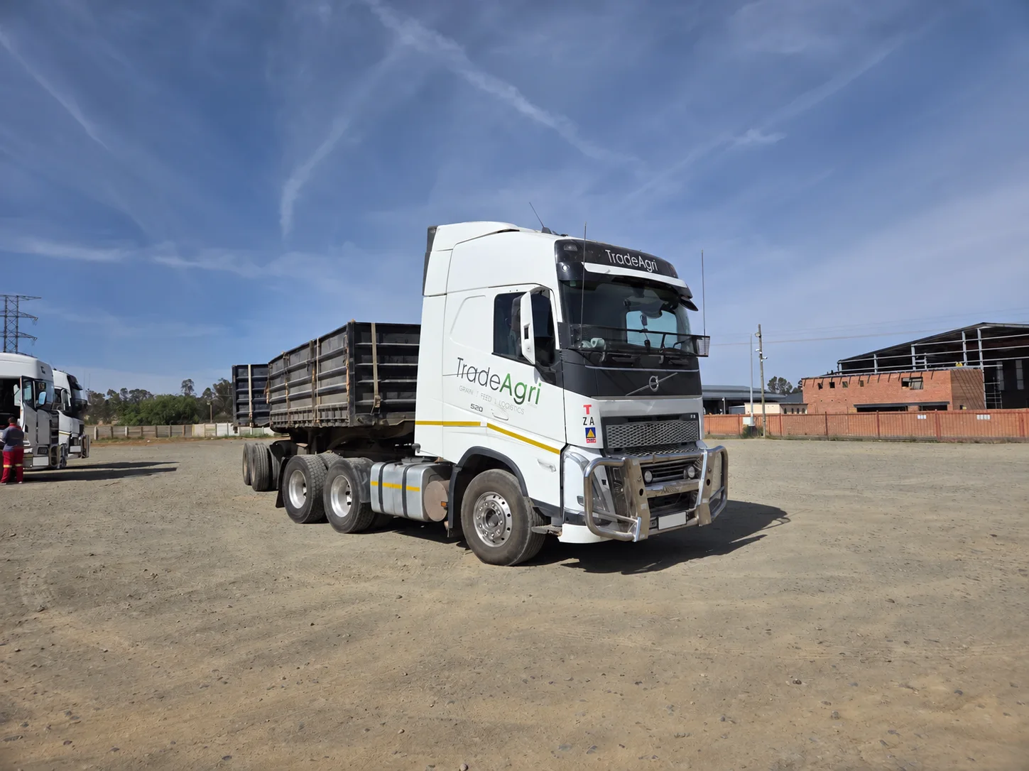 White Volvo FH 520 with a tipper trailer at a transport yard
